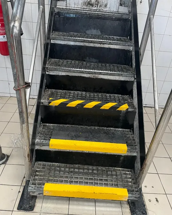 GRP anti-slip step covers on industrial steel grating stairs