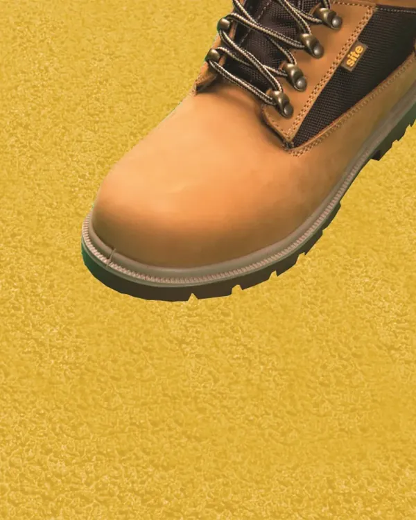 Safety boot on yellow anti-slip grit surface